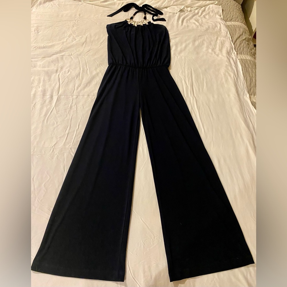 Navy blue jumpsuit with flared pant legs. Silver neckline. Good condition.